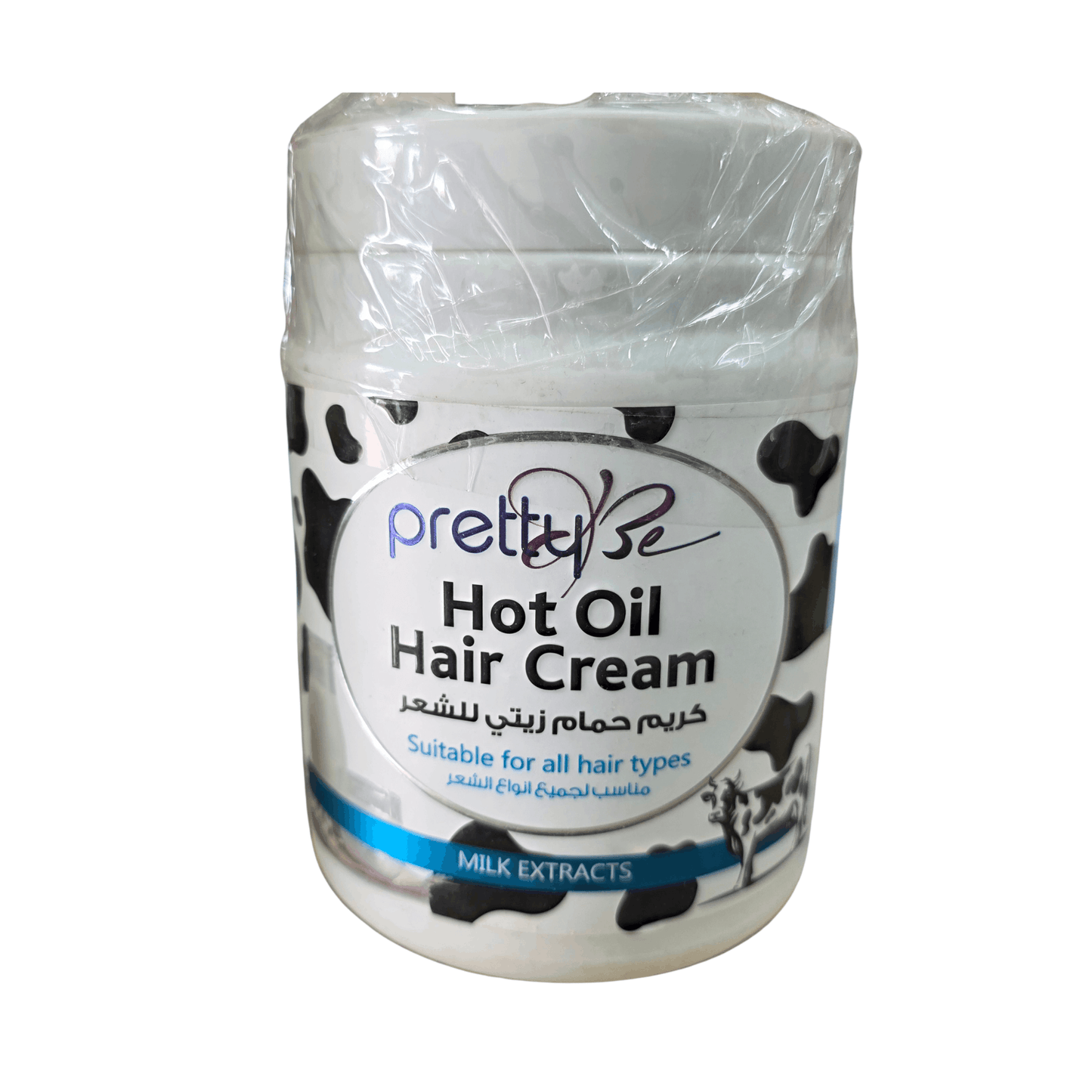 A jar of Pretty Se Hot Oil Hair Cream with a white label featuring black cow print spots, wrapped in clear plastic at the top, on a white background.