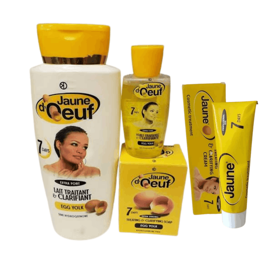 A set of four Jaune d'Ceuf 7 Days Egg Yolk hair care products, including a shampoo bottle, conditioner bottle, treatment shampoo tube, and two boxes, arranged on a plain white background.